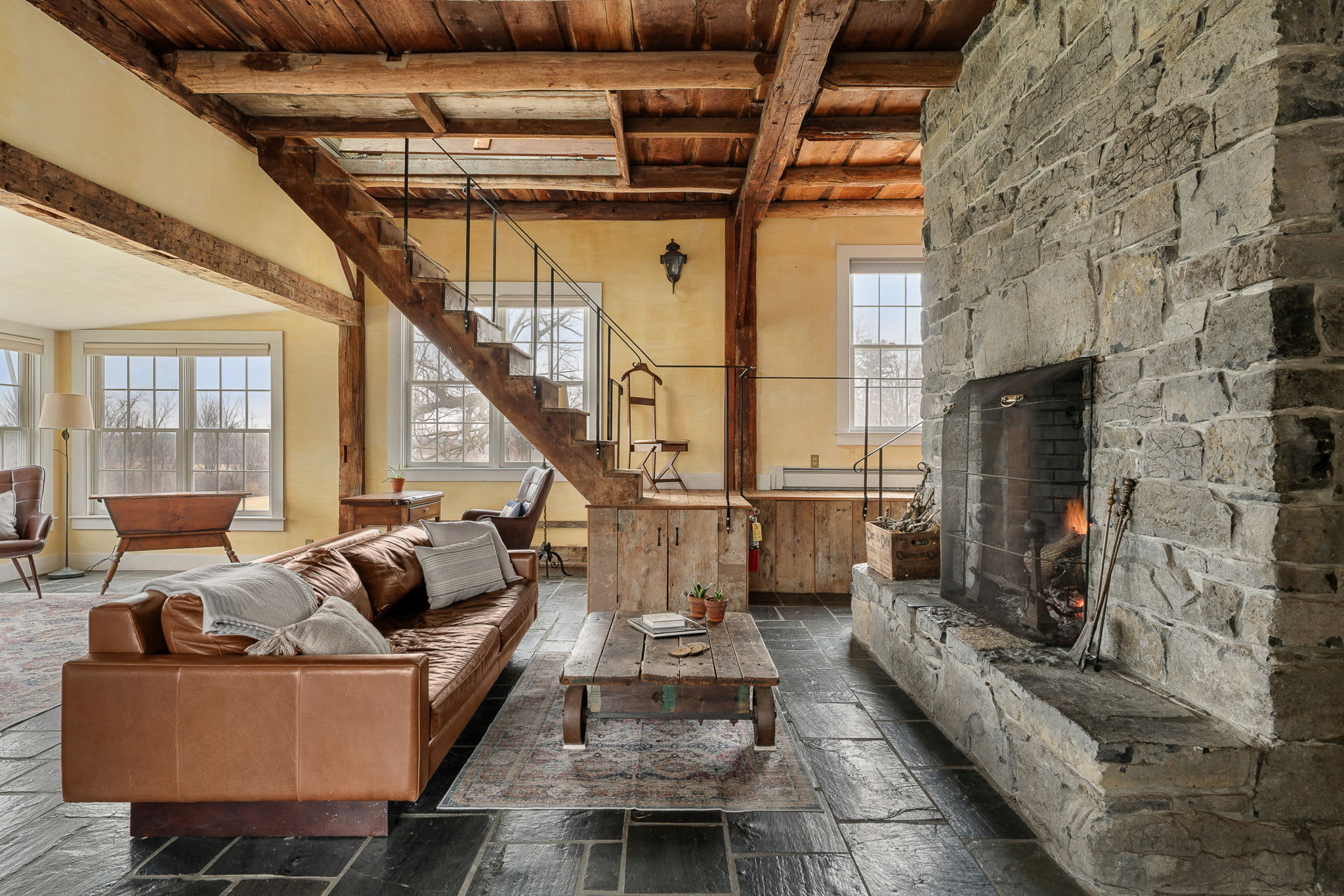 Farm House great room with stone fireplace